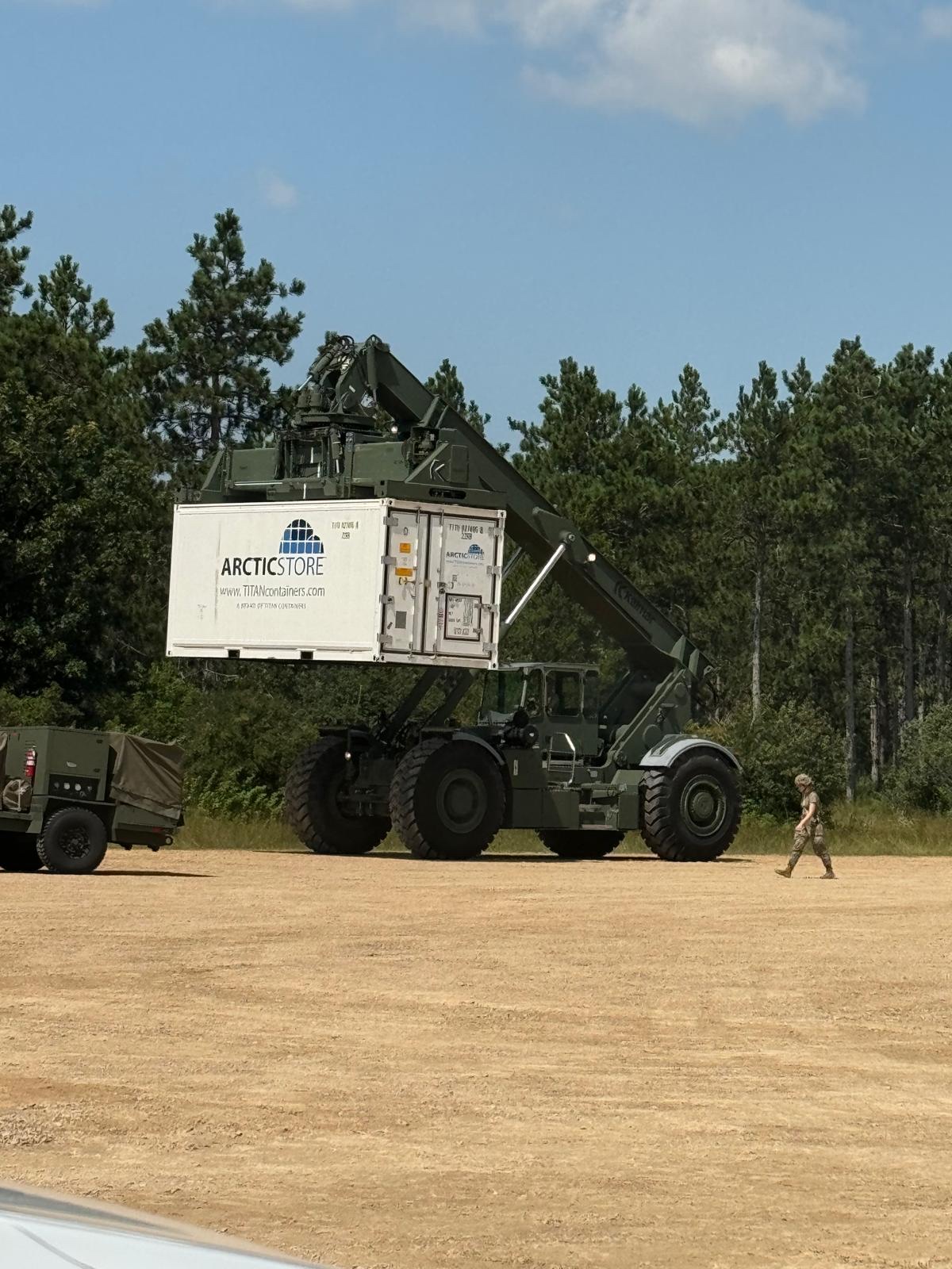 Reach-stacker handling a refrigerated container at an installation
